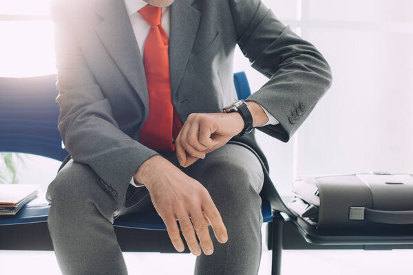 Corporate businessman checking time