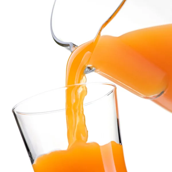 Pouring orange juice into glass — Stock Photo, Image