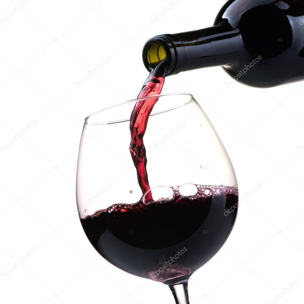 Pouring red wine into wineglass