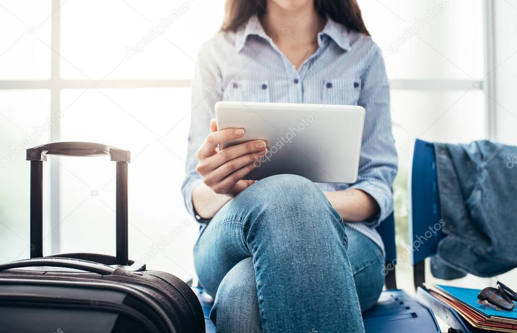 Young traveler woman sitting in terminal 