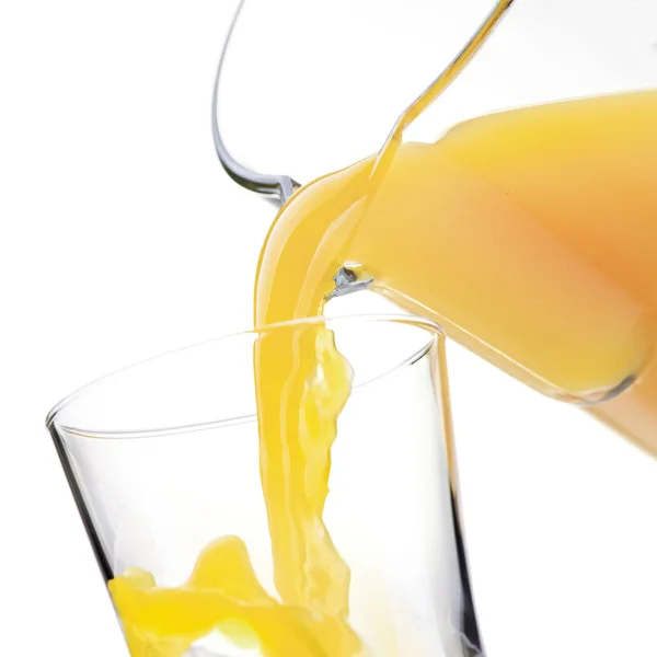 Pouring refreshing juice in glass — Stock Photo, Image