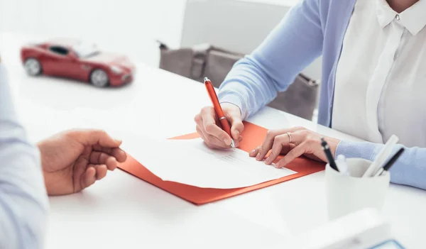 Mujer firma póliza de seguro de coche — Foto de Stock