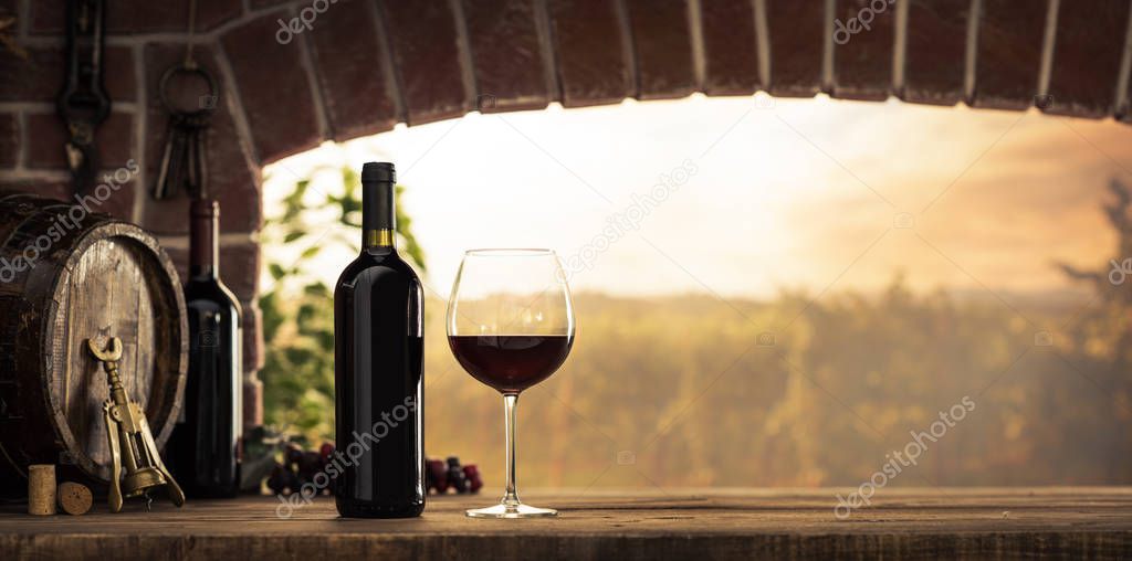 wineglass and bottles next to window