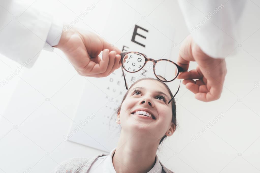 woman trying new pair of glasses 