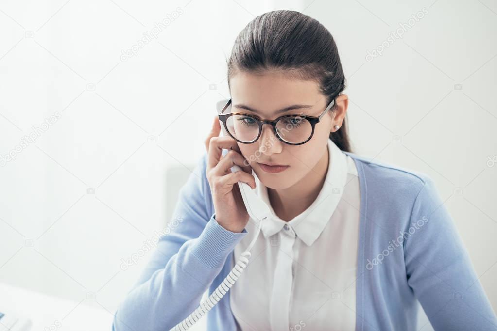 Young secretary working in office