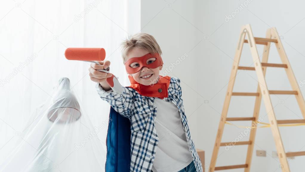 superhero boy holding paint roller
