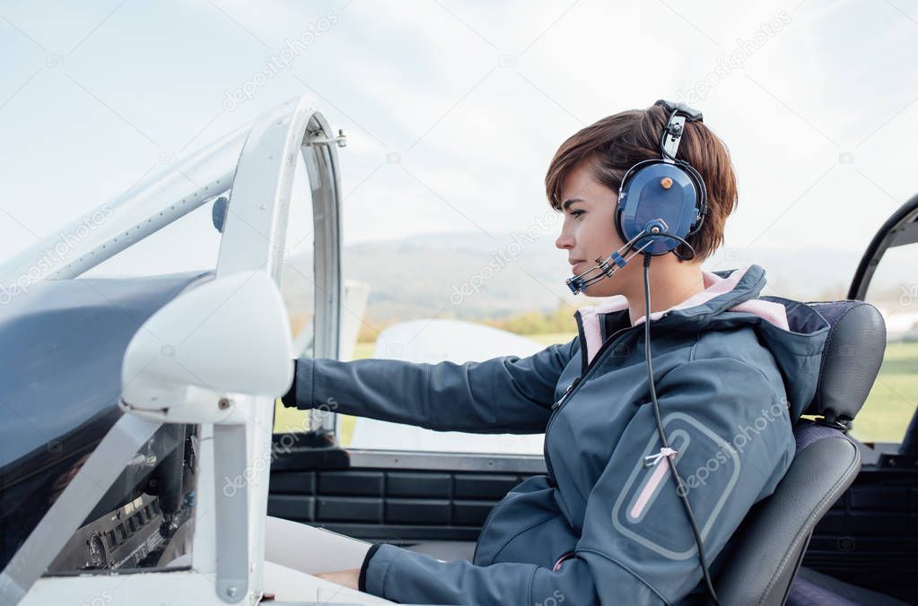 female pilot in aircraft cockpit