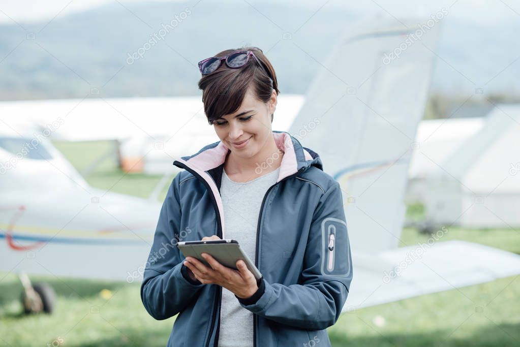 Female pilot with digital tablet