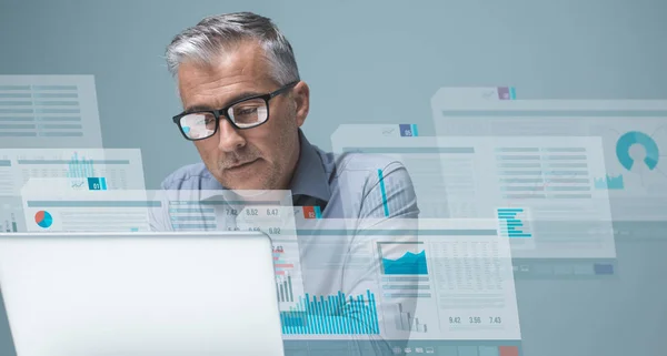 Businessman reading financial reports — Stock Photo, Image