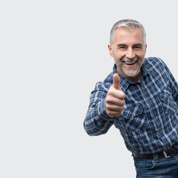 Cheerful man giving a thumb up