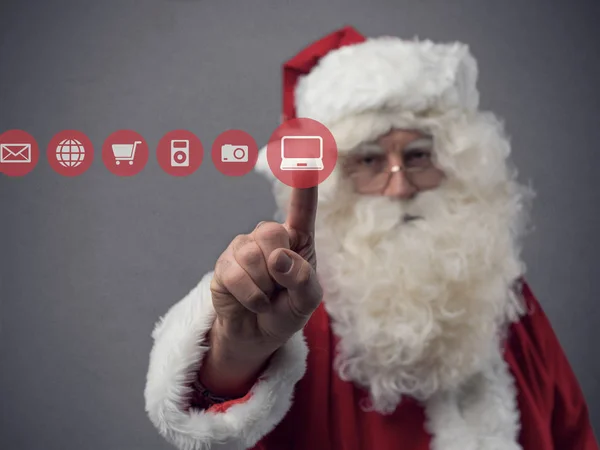 Kerstman met behulp van de gebruikersinterface van een touch-scherm — Stockfoto