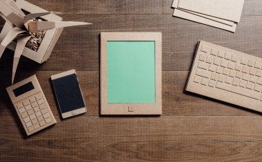 Tablet, smartphone ve geri dönüşümlü karton yapılır nesneleri ile yaratıcı çevre dostu Ofis Masası