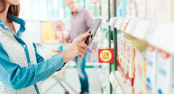 Mujer Compras Supermercado Ella Está Buscando Productos Ofertas Utilizando Teléfono —  Fotos de Stock