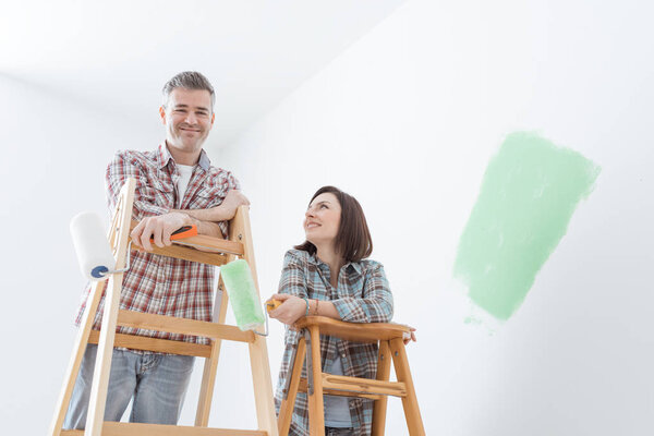 Happy couple painting home