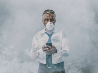 businessman with protective mask using smartphone clipart