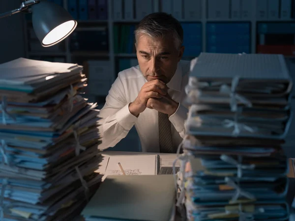 Exhausted businessman working in office — Stock Photo, Image