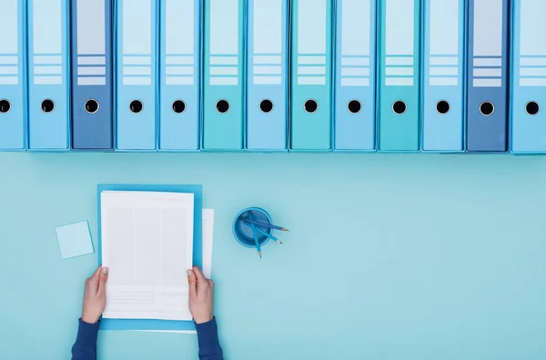 Office worker reading paperwork