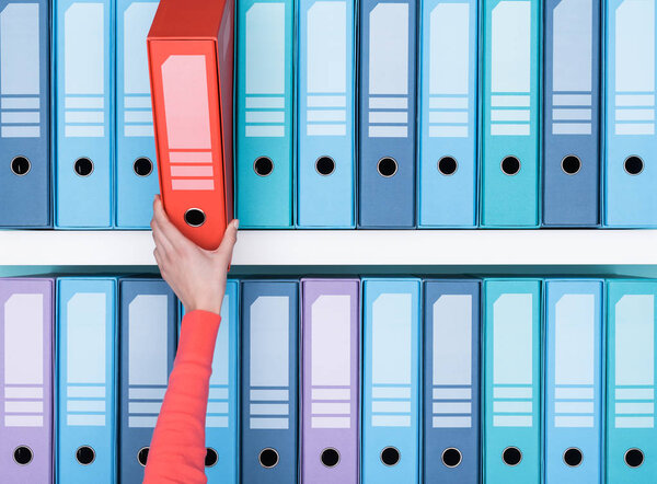 Office worker taking folder 