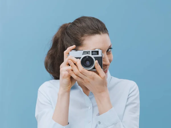 attractive woman holding vintage camera