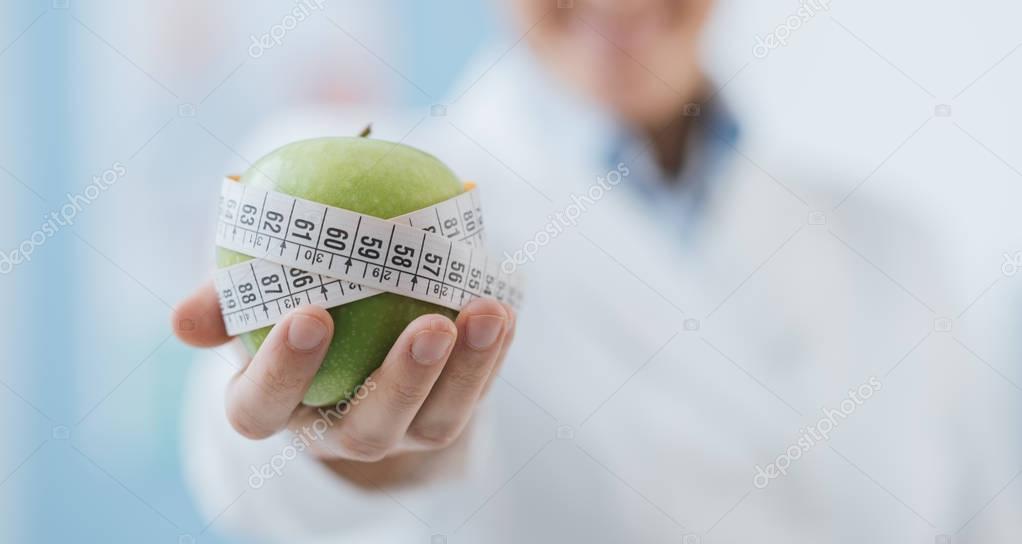 Professional nutritionist holding apple
