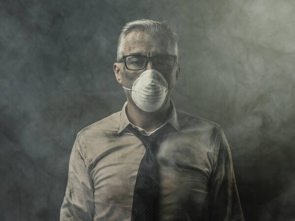 Corporate businessman wearing protective mask