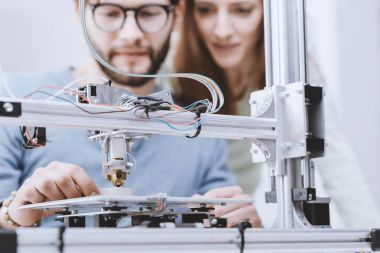 Okul laboratuarında bir 3d printerlere harcama maddeler kullanan öğrenciler gülümseyen, onlar prototip, teknoloji ve öğrenme kavramı yazdırıyorsanız