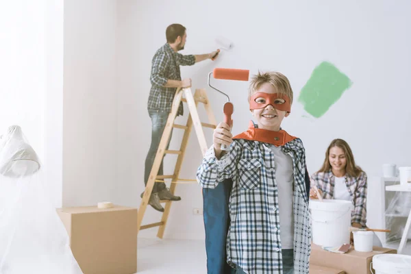 Family Renovating Home Painting Walls Boy Wearing Superhero Costume Holding — Stock Photo, Image