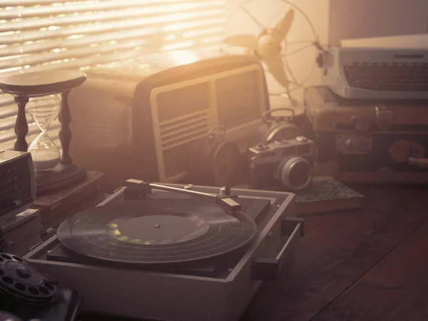 Vintage retro revival objects and appliances assortment on a table, turntable record player on the foreground