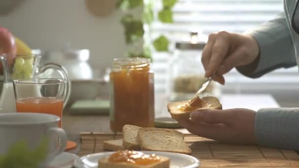 Женщина Готовит Здоровый Завтрак Дома Распространяет Варенье Поджаренный Хлеб Ломтики — стоковое видео
