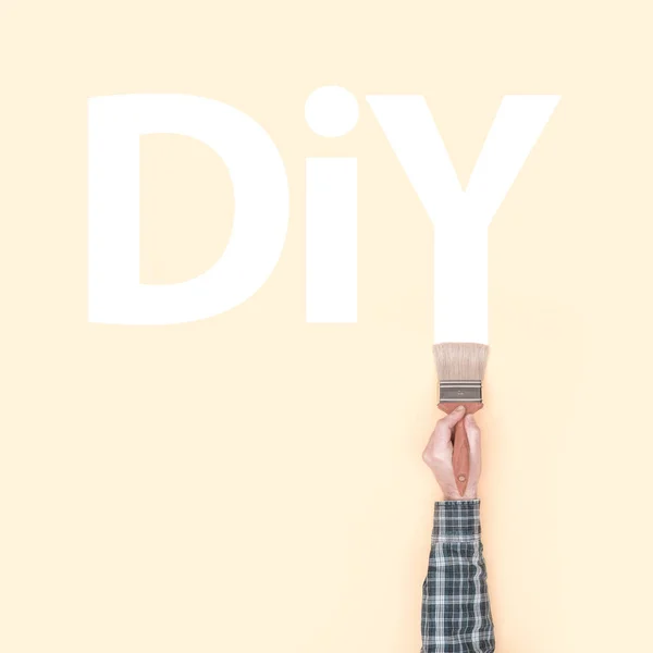 Decorator painting DIY on a wall — Stock Photo, Image