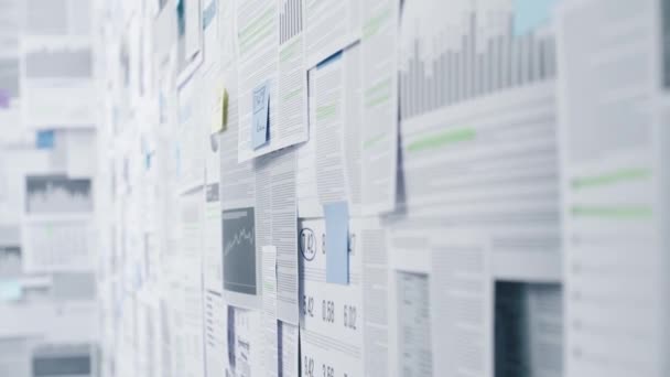 Lots of business reports and financial data on a wall — Stock Video