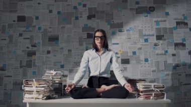 Collegues disturbing a businesswoman while she is meditating at work