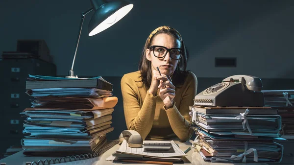 Pensive disappointed secretary working overtime — Stock Image Pensive disappointed secretary working overtime Royalty Free Stock Images