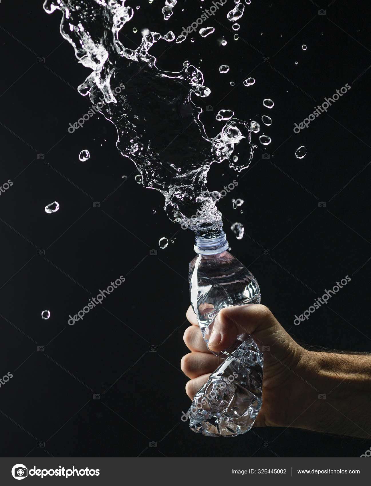 Hand crushing a water bottle Stock Photo by ©stokkete 326445002