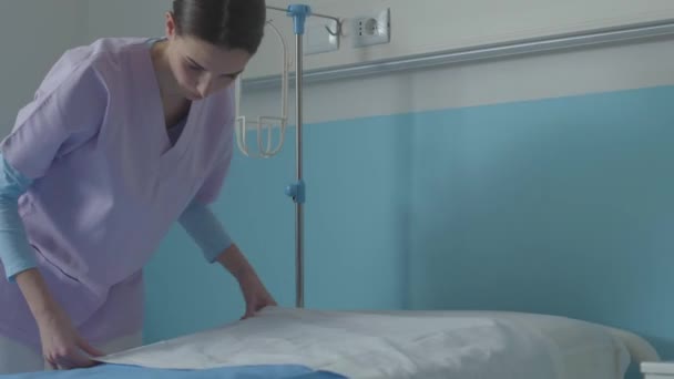 Enfermera experta haciendo la cama en el hospital — Vídeos de Stock