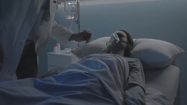 Arzt untersucht einen Patienten im Krankenhausbett — Stockvideo