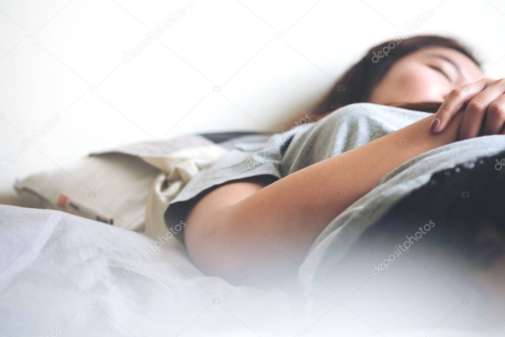 Asian woman is sleeping on bed