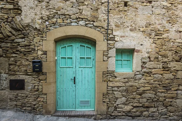 Синяя дверь в старом каменном здании — стоковое фото