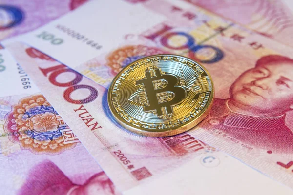Financial concept with golden Bitcoin over chinese yuan bill — Stock Photo, Image