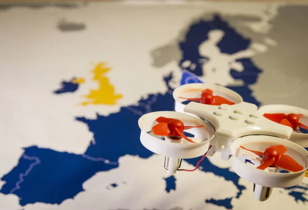 Mini drone flying over a EU map. European rules for drone aerial aircraft law concept