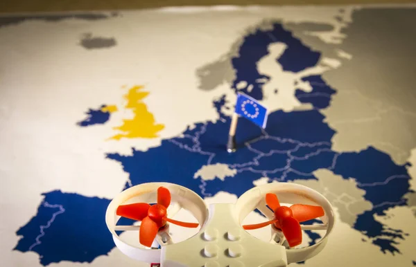 Mini drone flying over a EU map. European rules for drone aerial aircraft law concept