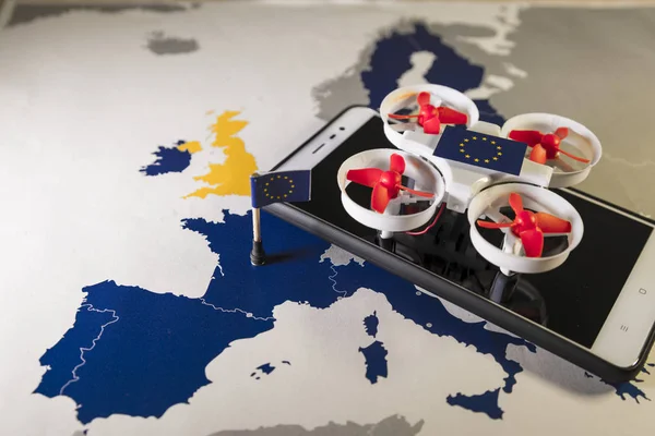 Mini drone flying over a EU map. European rules for drone aerial aircraft law concept