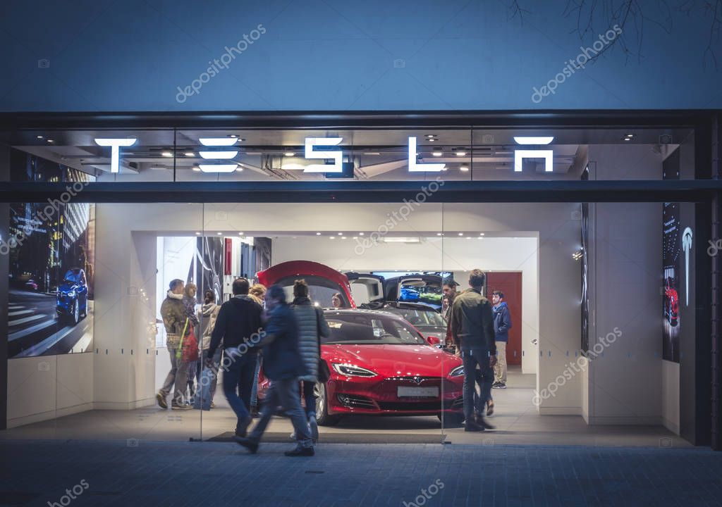 Barcelona, Spain. March 2018: Tesla inc cars flagship store near Passeig de Gracia luxury shopping street with Tesla logo and an electric cars model S and X inside