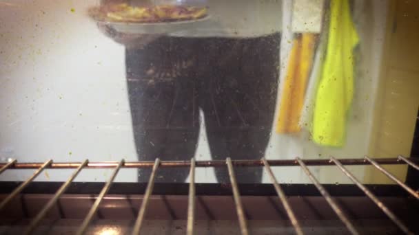 Putting coca de recapte into the oven — Stock Video