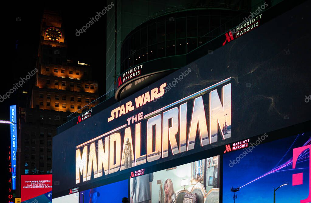 New York, USA. November 2019: Close up on illuminated billboard at Times Square showing the New Disney plus series The Mandalorian, the space western set in the Star wars universe.