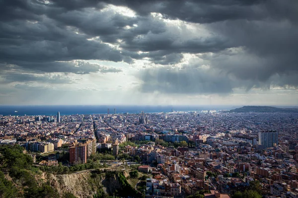 Panorama of Barcelona, Spain, viewed from the Bunkers of Carmel on a cloudy day with rays of light. — Stock Photo, Image