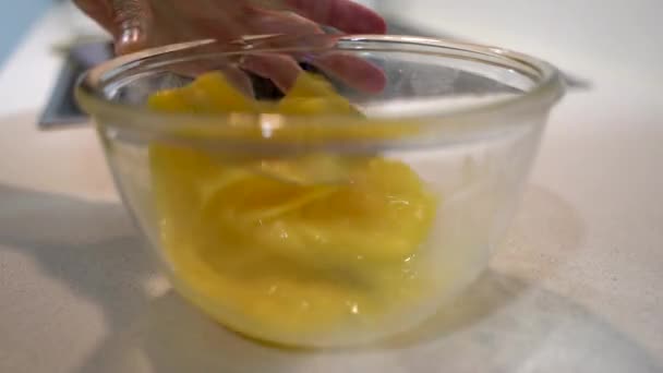 Female hands beating eggs with a whisk. — Stock Video