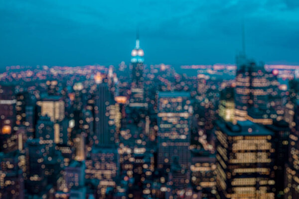 Defocused background of New York city at night. Tourism and city monument concept. Blurred post production for bokeh effect with Orange and teal look