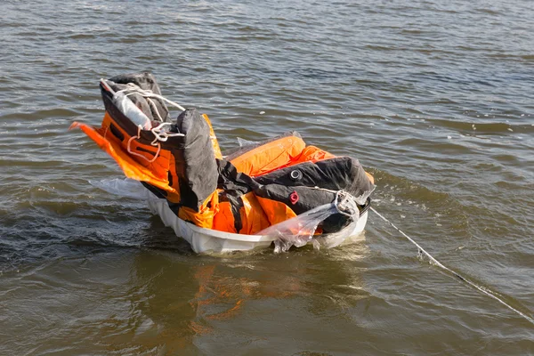 Rescue demonstration life raft opening in the water — Stock Photo, Image