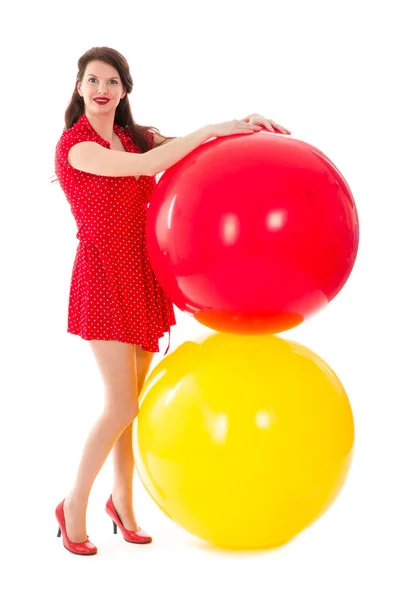 Beautiful woman in red dress with two big red and yellow balloons — Stock Photo, Image